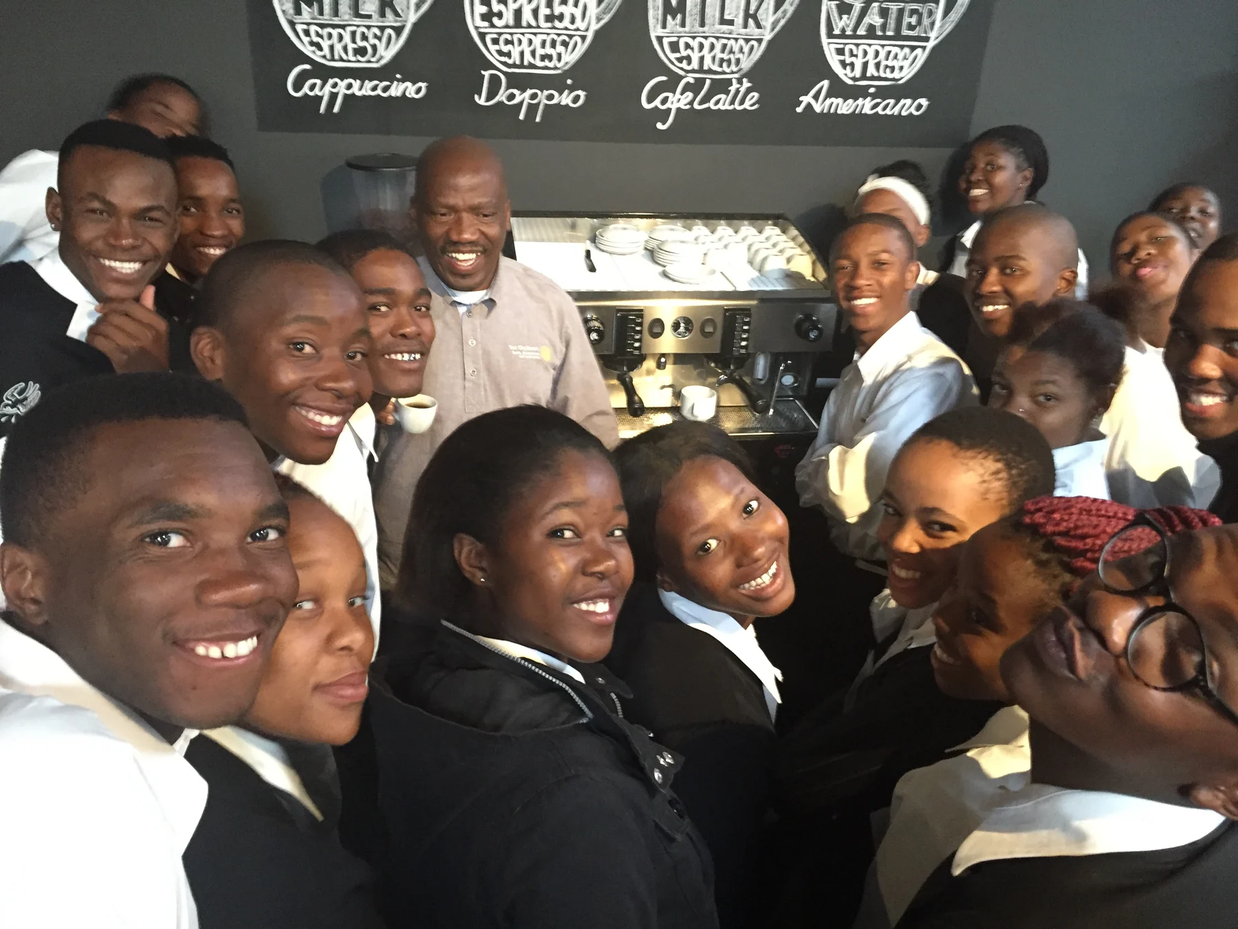 Peermont Hotel School students gathered around an espresso machine in 2016